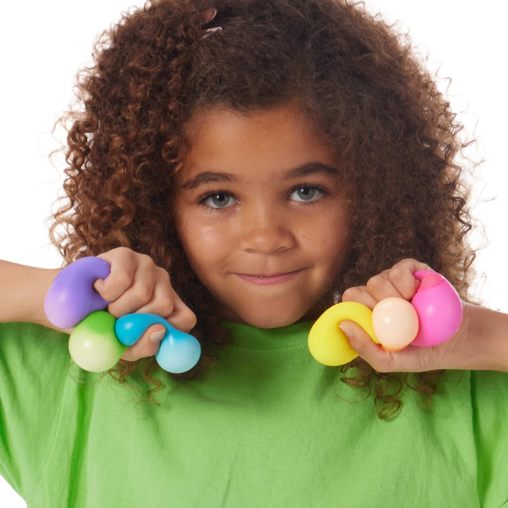 Girl squeezing 6 Rainboh Teenie NeeDoh